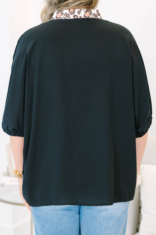 Plus Size black short dolman sleeve top with a leopard print split v-neckline trim.