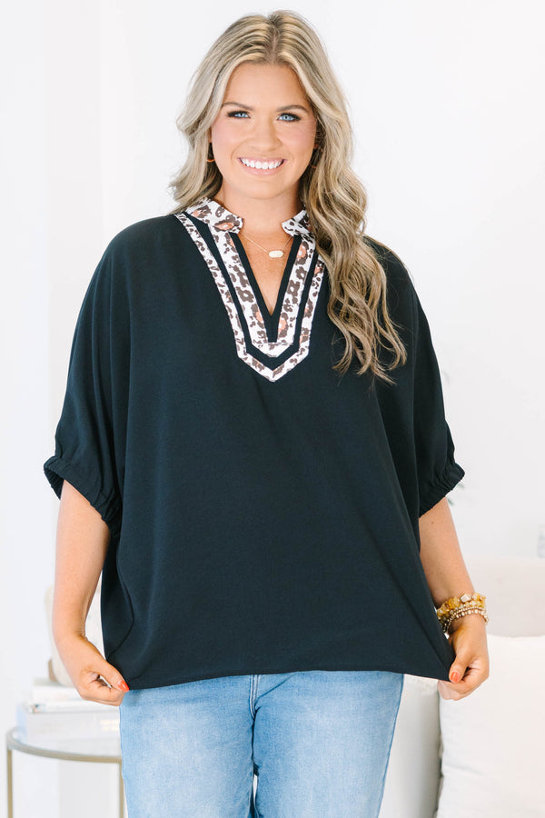 Plus Size black short dolman sleeve top with a leopard print split v-neckline trim.