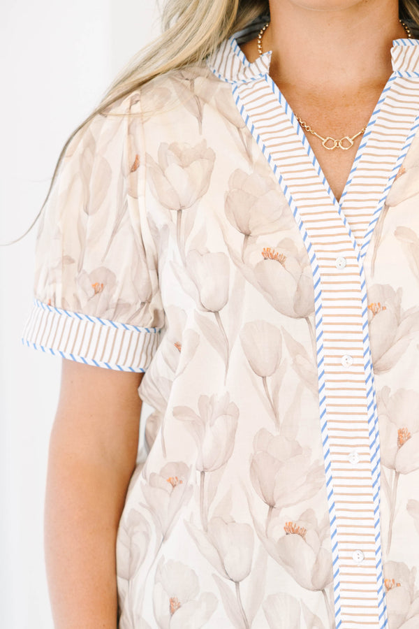 Plus Size cream floral button-down top with puff sleeves and striped trim paired with light jeans.