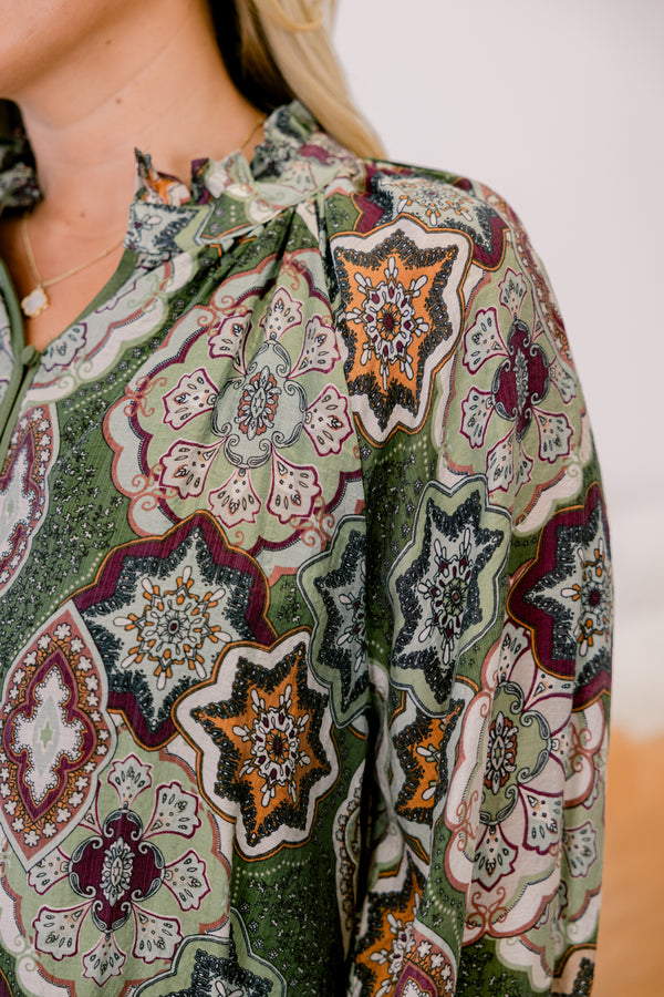 Chic Soul plus size clothing, olive green button up long sleeve blouse with cinched sleeves and a collar with abstract maroon and orange patterning. 