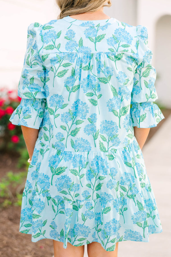 Plus size light blue tiered mini dress with a blue hydrangea floral print and ruffle sleeves.