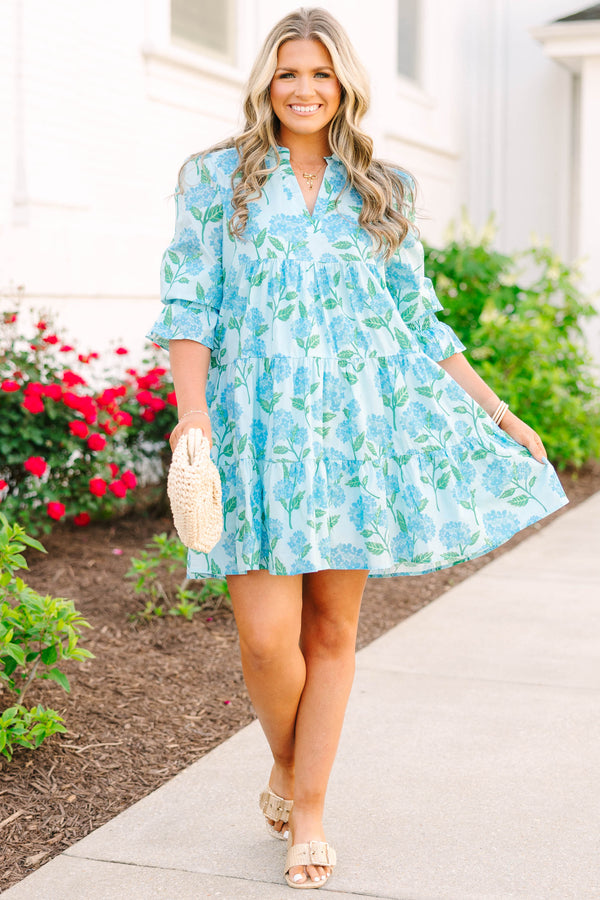 Plus size light blue tiered mini dress with a blue hydrangea floral print and ruffle sleeves.