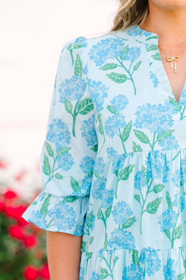 Plus size light blue tiered mini dress with a blue hydrangea floral print and ruffle sleeves.