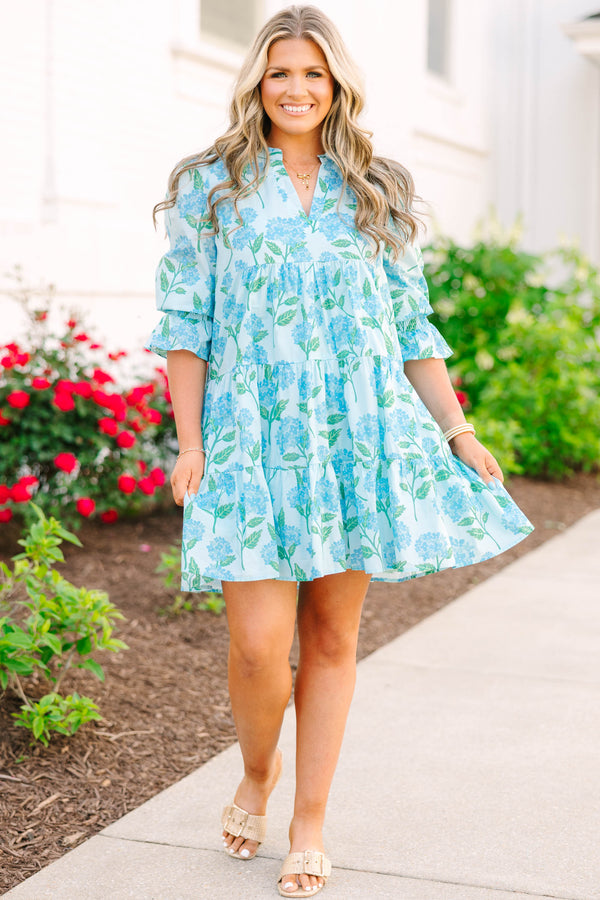 Plus size light blue tiered mini dress with a blue hydrangea floral print and ruffle sleeves.