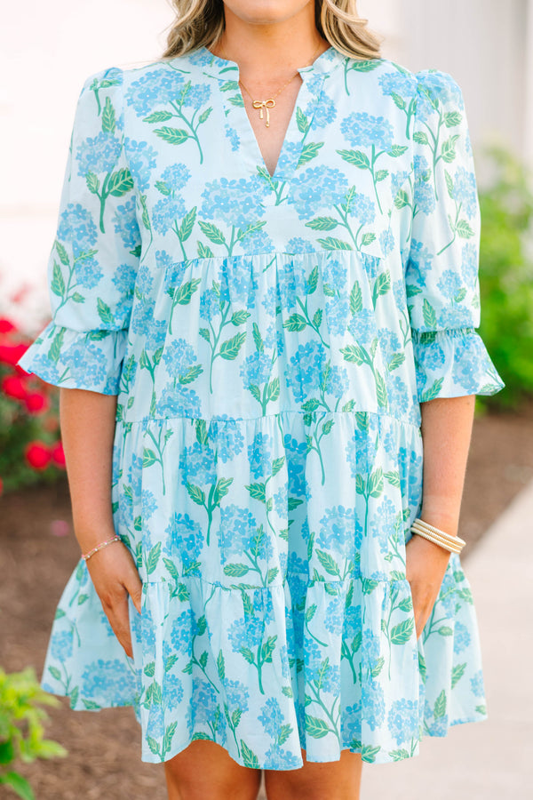 Plus size light blue tiered mini dress with a blue hydrangea floral print and ruffle sleeves.