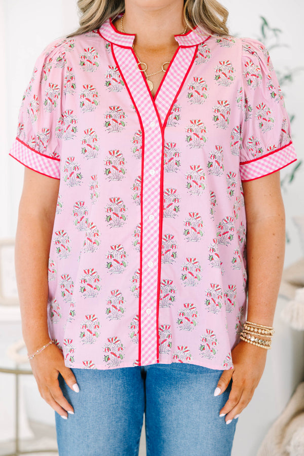 Plus size pink floral top with gingham trim, puff sleeves, and a button-down v-neckline.