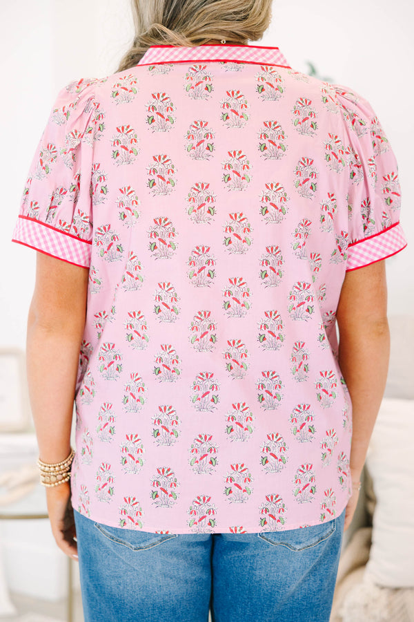 Plus size pink floral top with gingham trim, puff sleeves, and a button-down v-neckline.