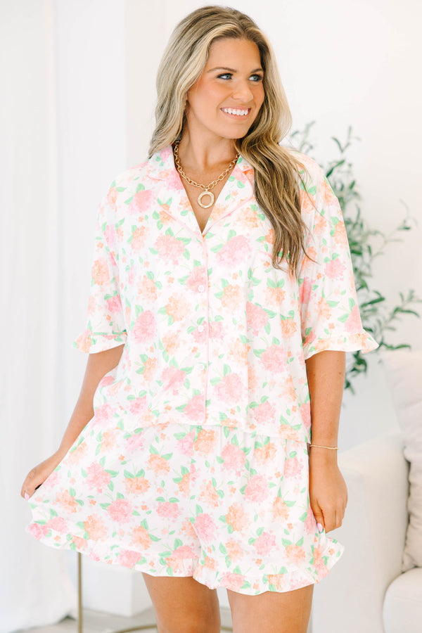 Plus Size pink hydrangea floral pajama set with a button-down short sleeve top and ruffled shorts.