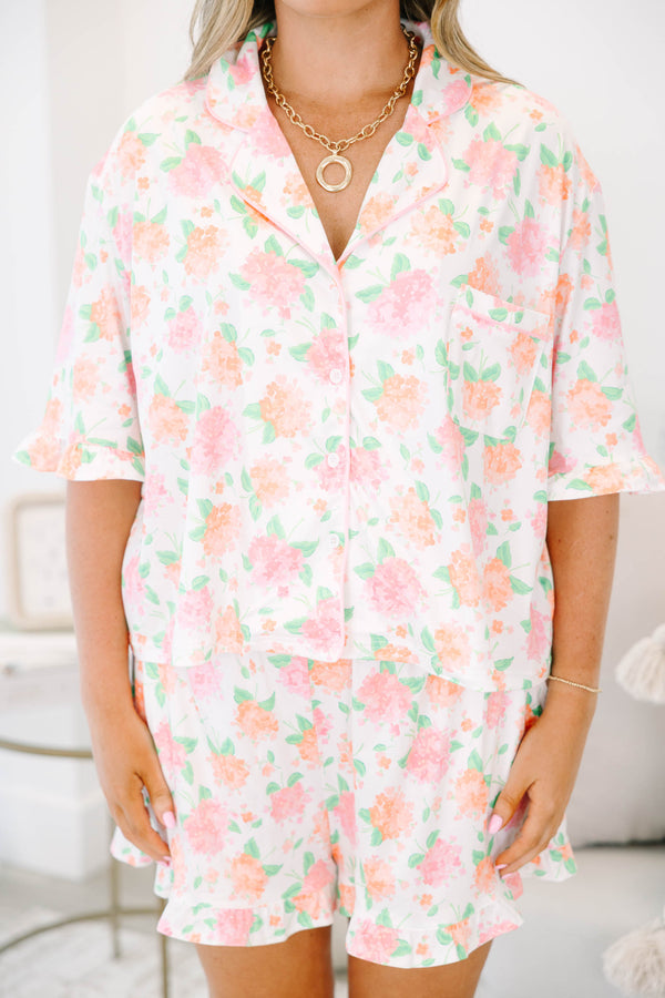 Plus Size pink hydrangea floral pajama set with a button-down short sleeve top and ruffled shorts.