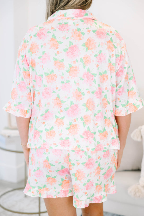 Plus Size pink hydrangea floral pajama set with a button-down short sleeve top and ruffled shorts.