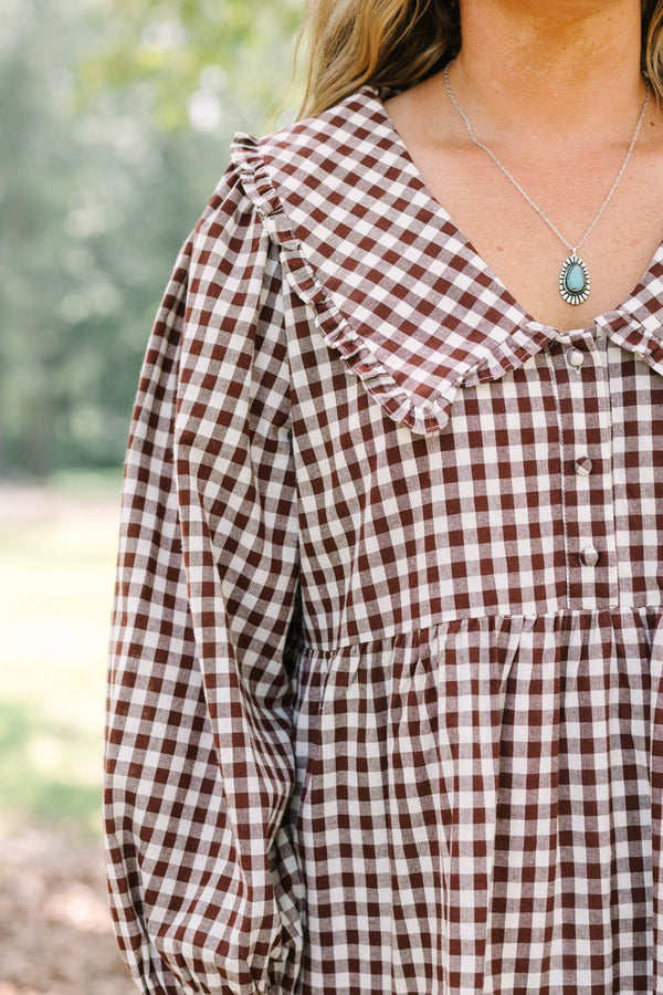 Plus Size brown gingham tiered dress with a wide collar, button front, and long puff sleeves.