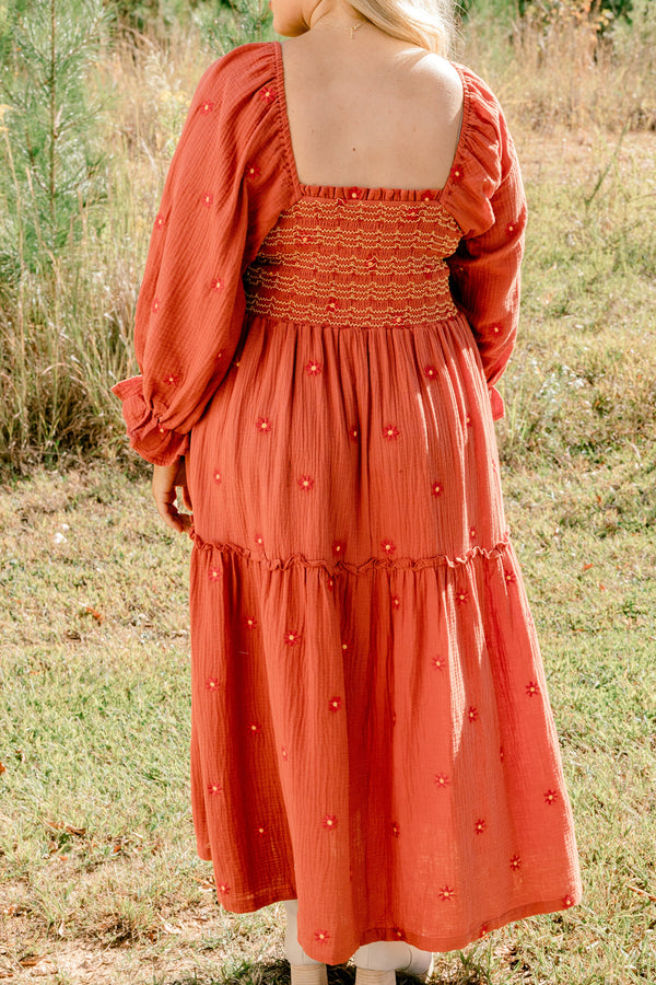 Chic Soul plus size clothing, rust orange long sleeve maxi dress with tiered skirt, embroidered dark orange flowers, and light yellow and orange stitching through stretchy top