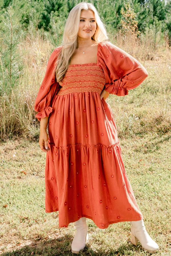 Chic Soul plus size clothing, rust orange long sleeve maxi dress with tiered skirt, embroidered dark orange flowers, and light yellow and orange stitching through stretchy top