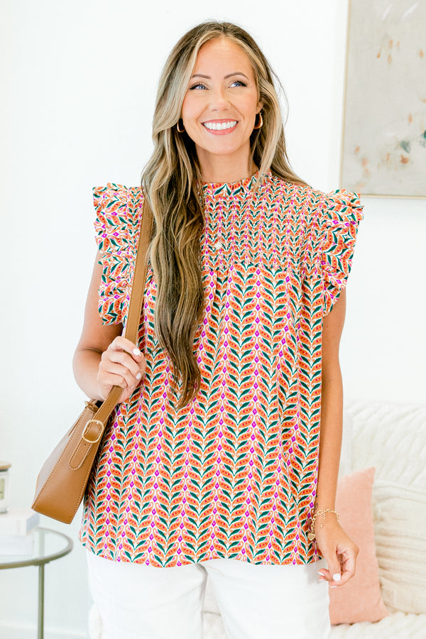 Chic Soul plus size clothing, sleeveless rust orange top with smocked high neckline and geometric pattern with ruffled sleeves