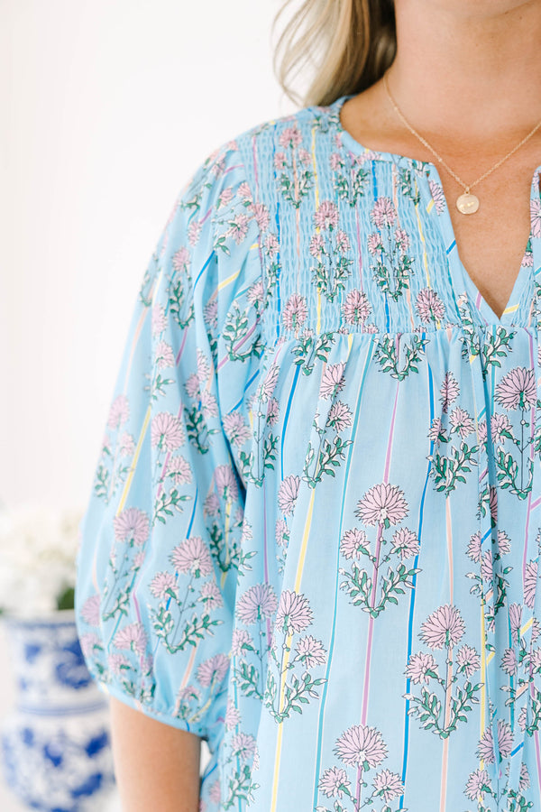 Plus Size blue floral smocked top with vertical stripes and elastic bubble sleeves.