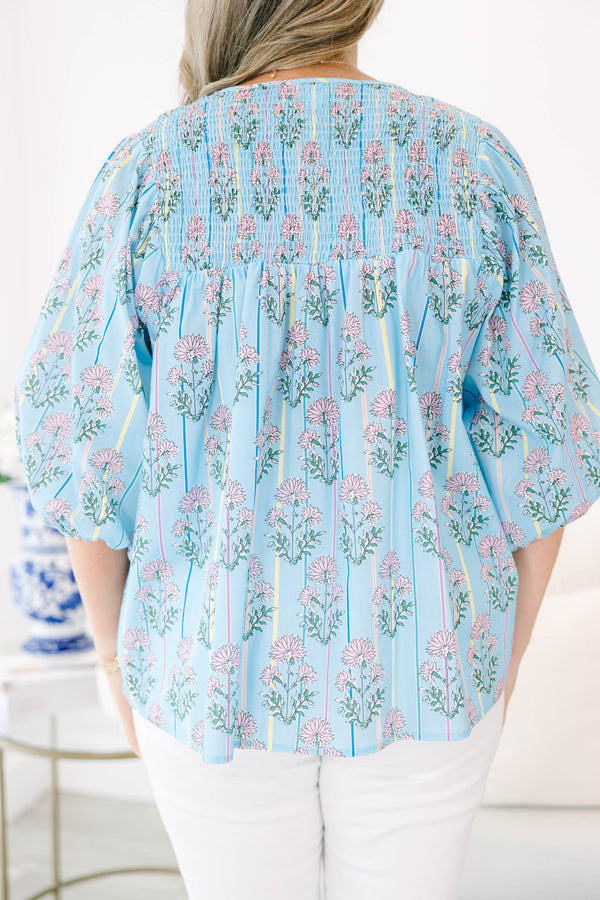 Plus Size blue floral smocked top with vertical stripes and elastic bubble sleeves.