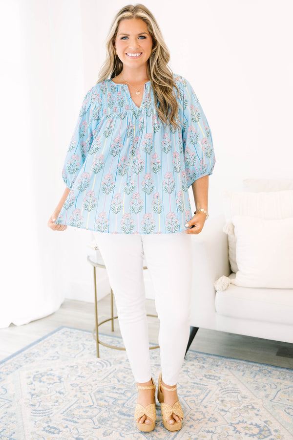 Plus Size blue floral smocked top with vertical stripes and elastic bubble sleeves.