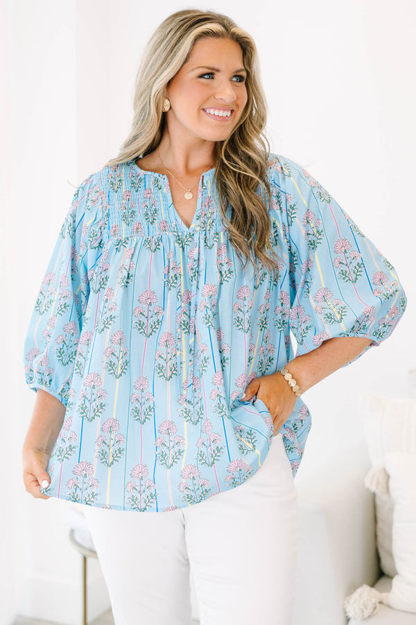 Plus Size blue floral smocked top with vertical stripes and elastic bubble sleeves.