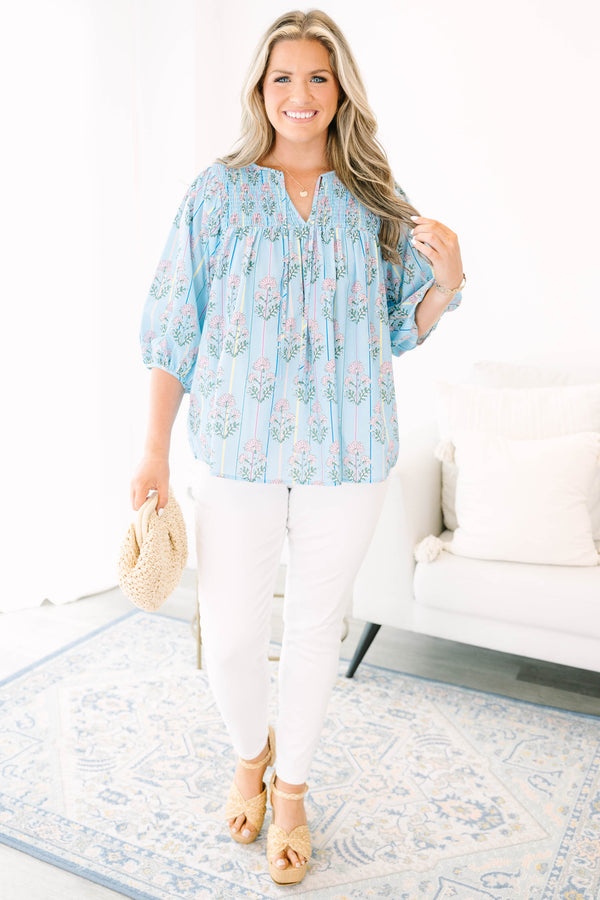 Plus Size blue floral smocked top with vertical stripes and elastic bubble sleeves.
