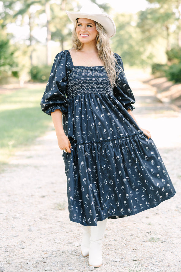 Plus Size black floral midi dress with a smocked bodice, square neckline, and long puff sleeves.