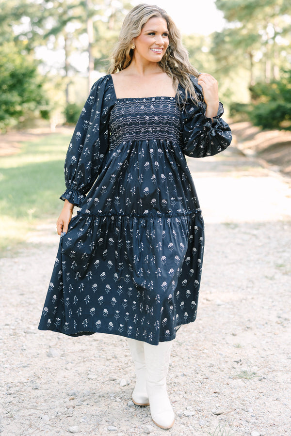 Plus Size black floral midi dress with a smocked bodice, square neckline, and long puff sleeves.