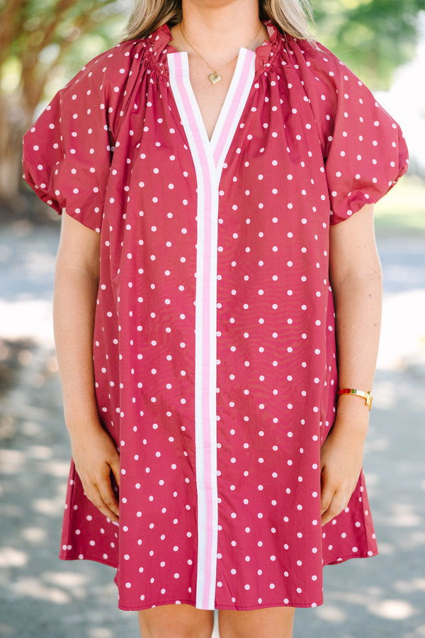 Plus size red polka-dot mini dress with a ruffled split V-neckline and flowy short sleeves.