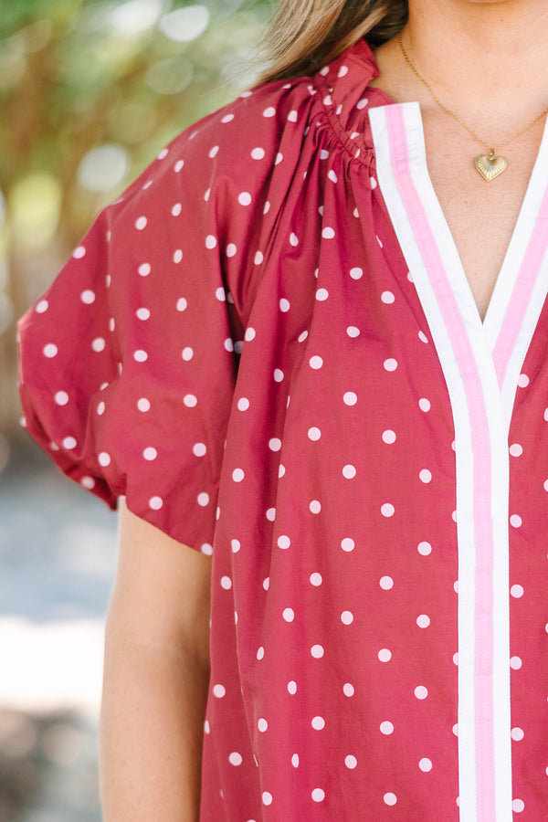 Plus size red polka-dot mini dress with a ruffled split V-neckline and flowy short sleeves.