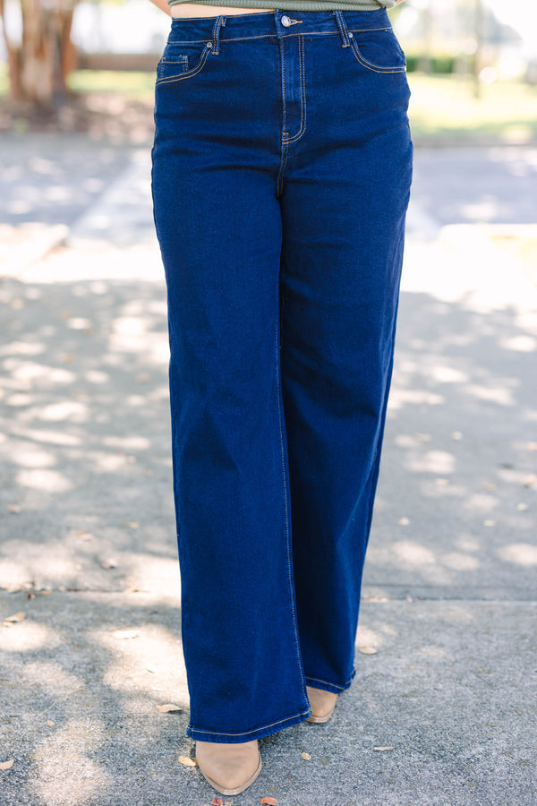 Plus size dark wash wide leg jeans with a high waist and stretchy denim fit.