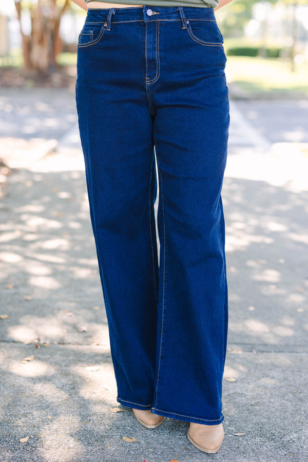 Plus size dark wash wide leg jeans with a high waist and stretchy denim fit.