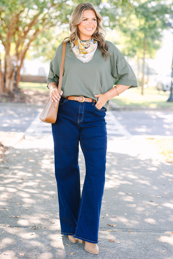 Plus size dark wash wide leg jeans with a high waist and stretchy denim fit.