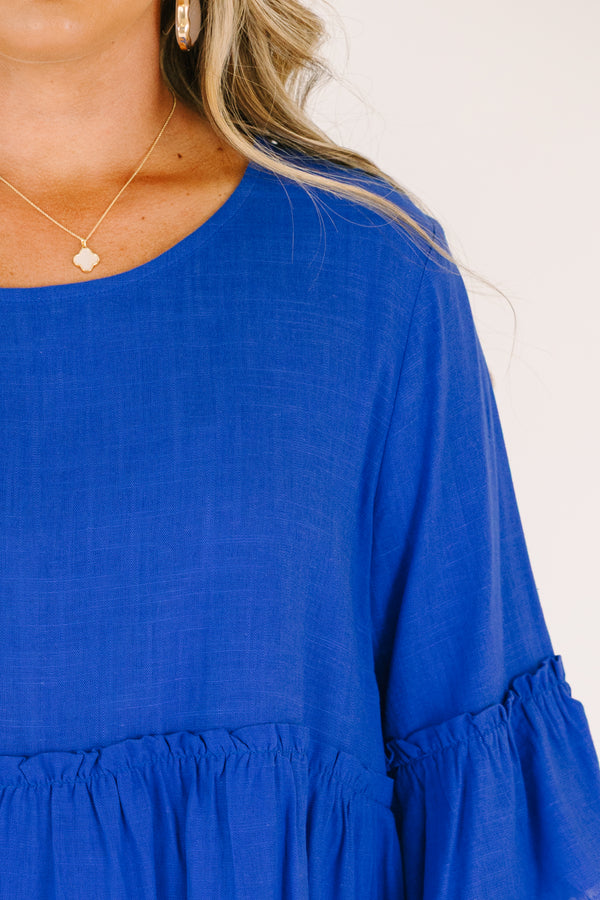 Plus Size cobalt blue babydoll top with ruffled elbow-length sleeves and a round neckline.