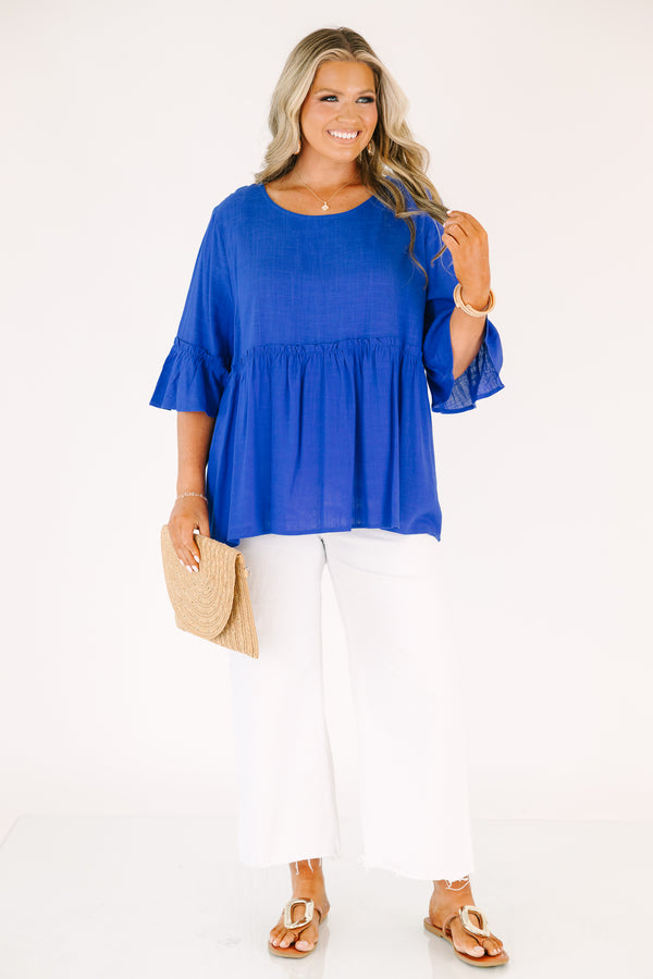 Plus Size cobalt blue babydoll top with ruffled elbow-length sleeves and a round neckline.
