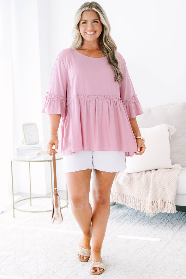 Plus size pink babydoll top with ruffle half sleeves and a flowy tiered silhouette.