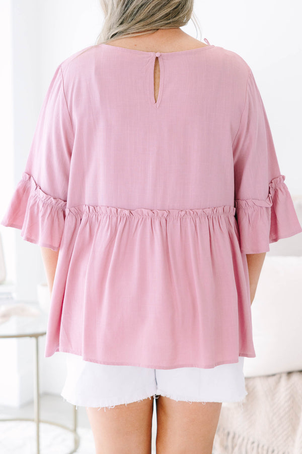 Plus size pink babydoll top with ruffle half sleeves and a flowy tiered silhouette.