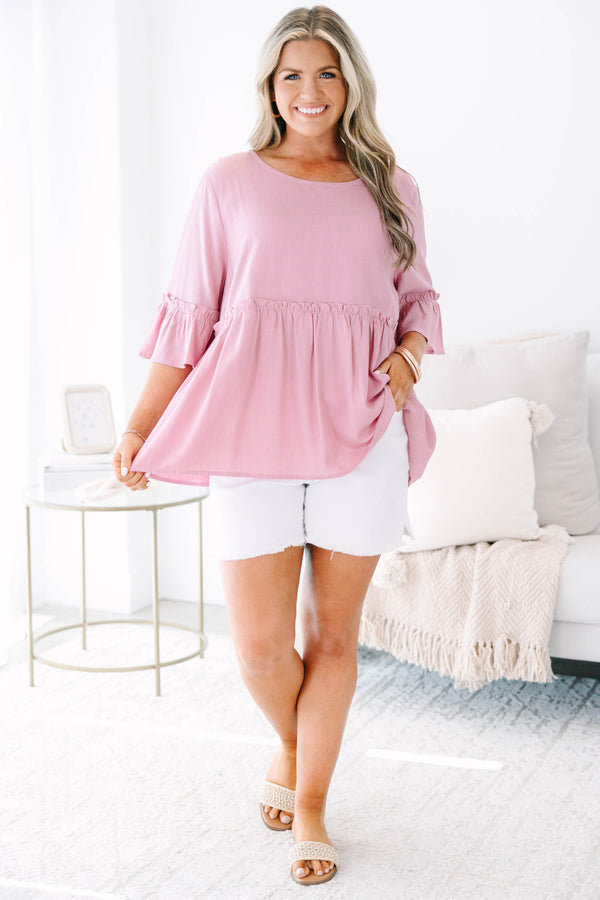 Plus size pink babydoll top with ruffle half sleeves and a flowy tiered silhouette.