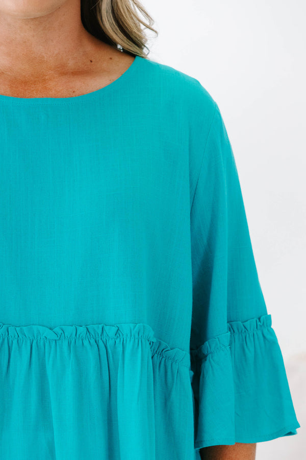 Plus Size teal babydoll top with ruffled three-quarter sleeves and a round neckline.