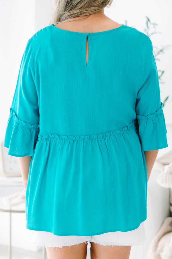Plus Size teal babydoll top with ruffled three-quarter sleeves and a round neckline.
