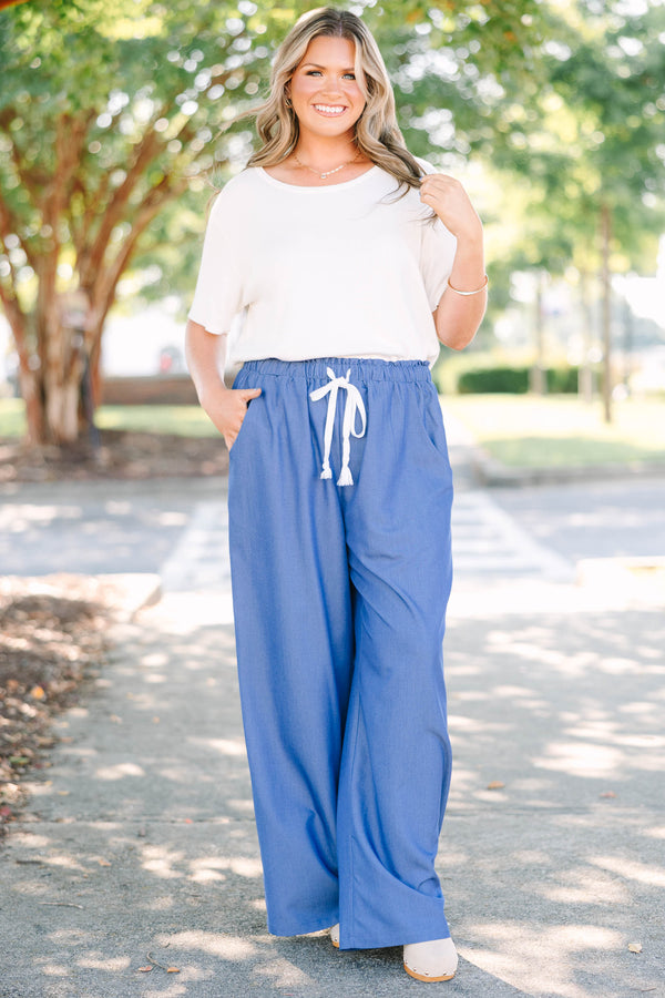 Plus Size wide-leg denim blue pants with an elastic drawstring waistband and side pockets.