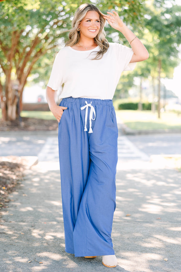 Plus Size wide-leg denim blue pants with an elastic drawstring waistband and side pockets.