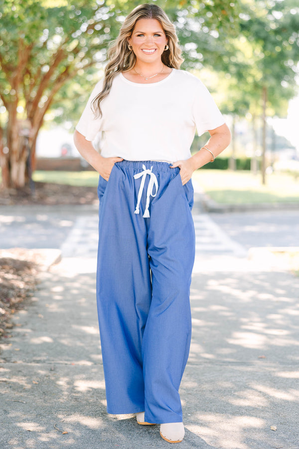 Plus Size wide-leg denim blue pants with an elastic drawstring waistband and side pockets.