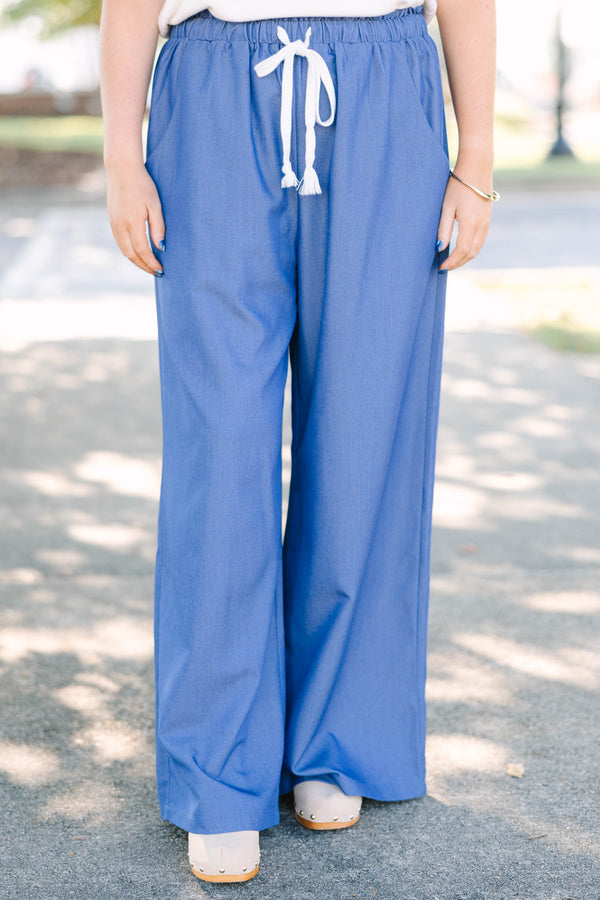 Plus Size wide-leg denim blue pants with an elastic drawstring waistband and side pockets.