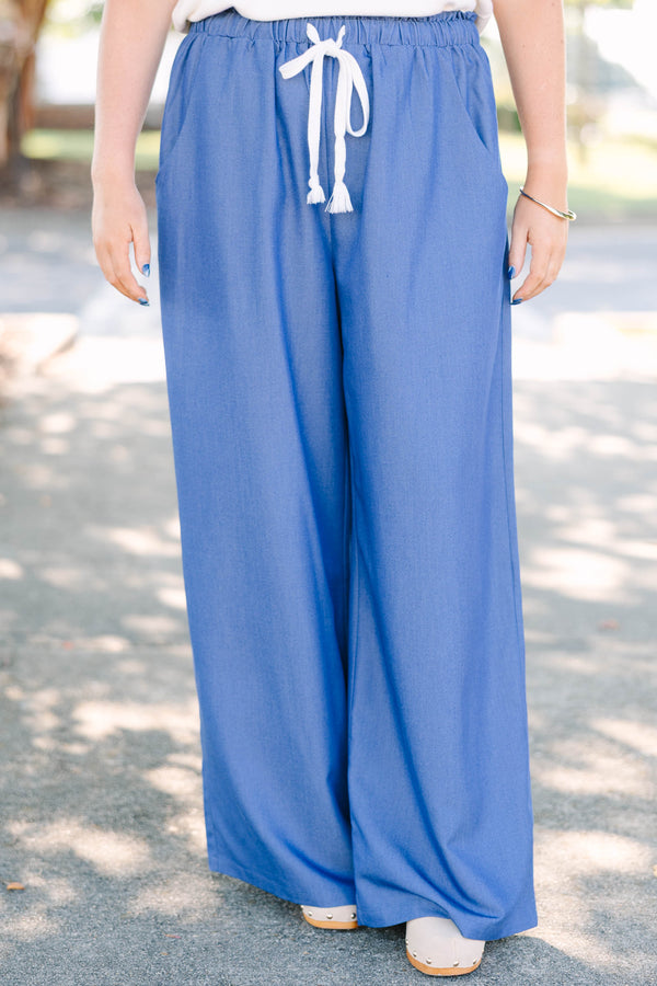 Plus Size wide-leg denim blue pants with an elastic drawstring waistband and side pockets.