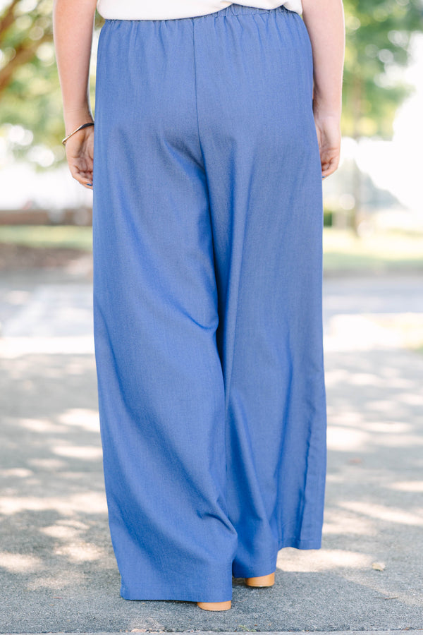 Plus Size wide-leg denim blue pants with an elastic drawstring waistband and side pockets.
