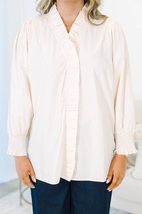 Plus size ecru cotton top with ruffle trim, smocked cuffs, and a flowy, feminine fit.