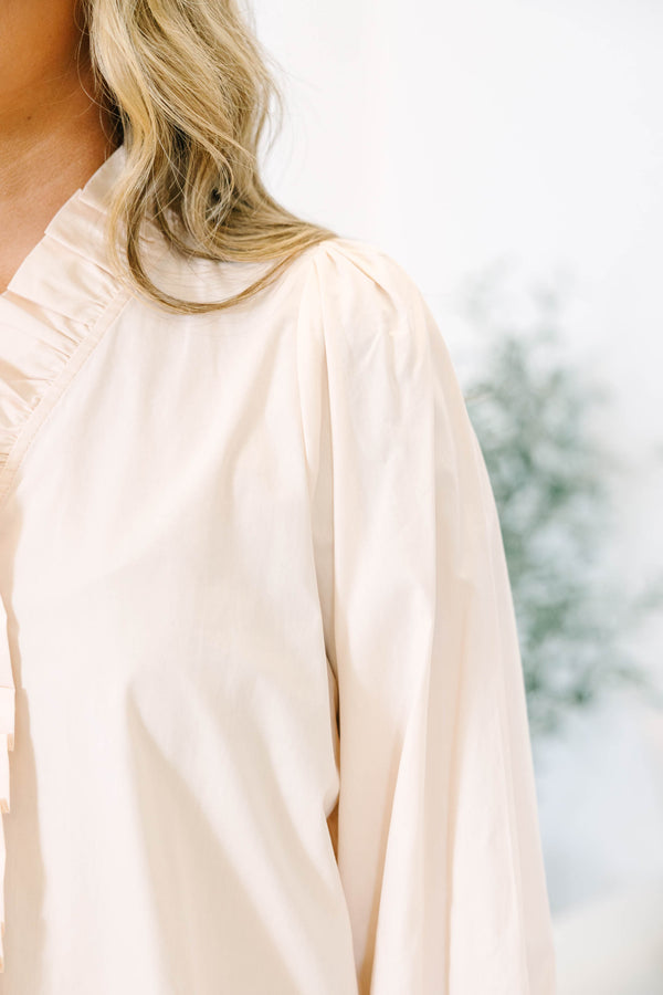 Plus size ecru cotton top with ruffle trim, smocked cuffs, and a flowy, feminine fit.