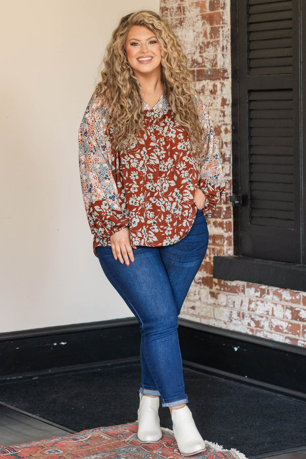 Chic Soul plus size clothing, rust colored top with floral patterned sleeves and larger floral detailing along the bodice