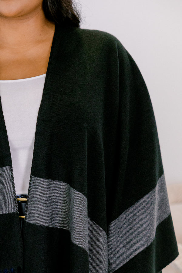 Chic Soul plus size clothing, black poncho sweater with thick grey horizontal stripe around the trim and fringe on the edge 
