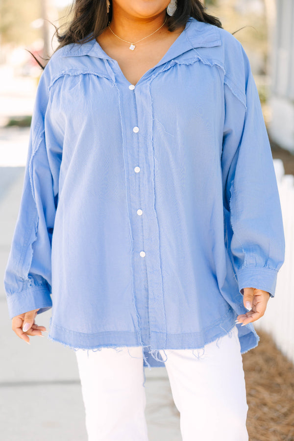 Chic Soul plus size clothing, blue long sleeve button up top with white button details going down the center of the shirt as well as cuffs at the end of each sleeve and a distressed fringe look at the bottom of the top