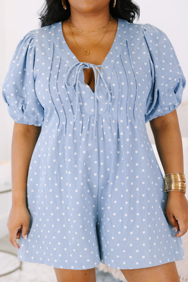 Plus size blue polka dot romper with a keyhole tie front, puff sleeves, and a flowy fit.