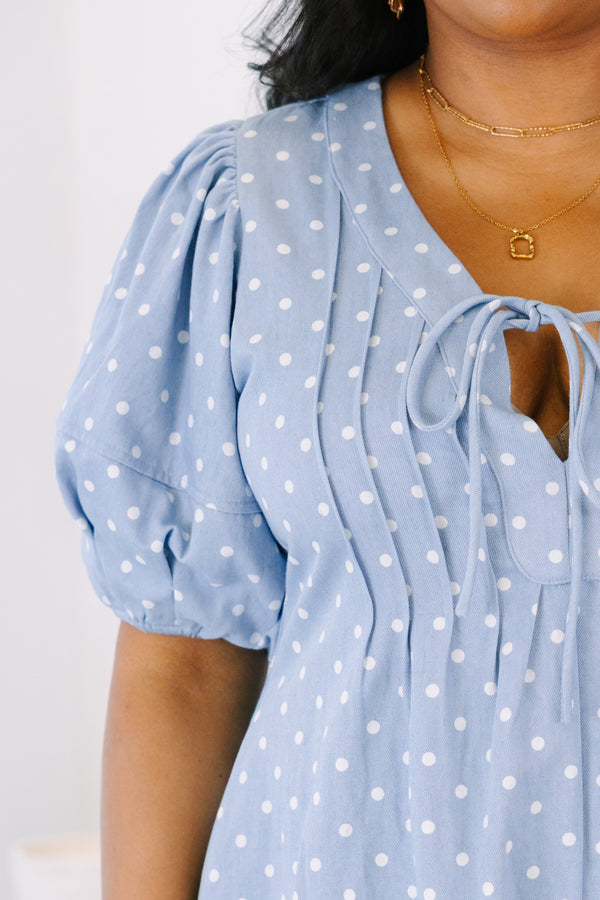 Plus size blue polka dot romper with a keyhole tie front, puff sleeves, and a flowy fit.